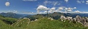 66 Alla croce di vetta della Corna Grande (2089 m) vista panoramica dalla Grigne al Tre Signori e oltre